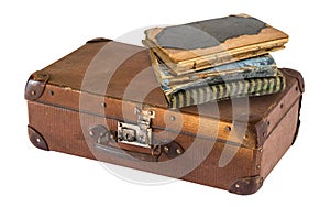 Old suitcase and books isolated on white background. Retro style