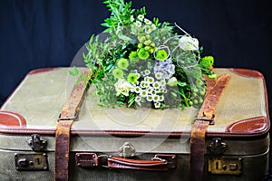 Old suitcase with bunch of flowers