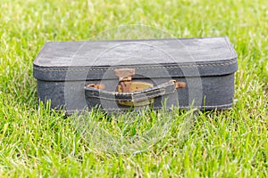 Old suitcase on grass