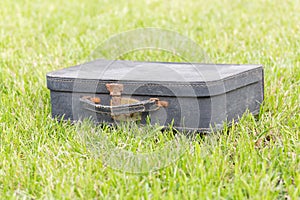 Old suitcase on grass