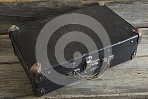 Old suitcase on a old wooden background