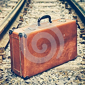 Old suitcase on the railway