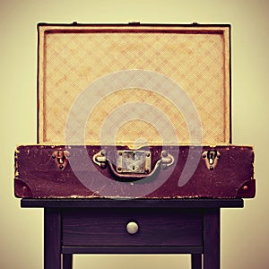 Old suitcase on a table, with a retro effect