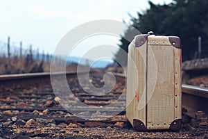 Old suitcase at the train station with retro effect