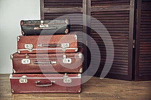 Old suitcases and dark wooden screen