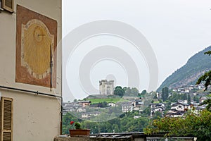 Old sun clock painted on a building wall.