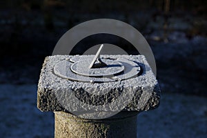 Old sundial on a cold morning