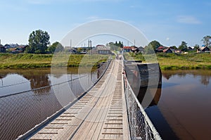 Old suspension bridge over the River Tura photo
