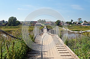 Old suspension bridge over the River Tura photo