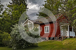 Old Swedish house with a garden inside the forest.