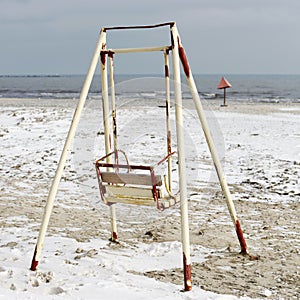 Old swing on the beach
