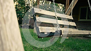 Old swing in the yard with light effect.