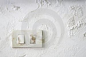 Old switch on the damp wall