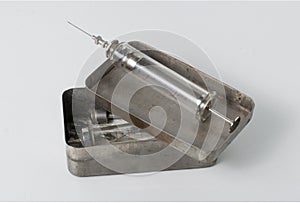 Old syringe with opened sterilizing box