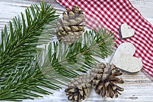 At an old table the Christmas decoration is placed ready