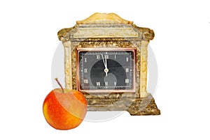 Old table clock and apple