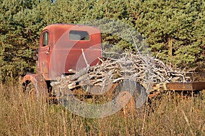 Old tandem junker truck loaded with branches photo