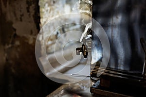 An old tap with hot water\'s smoke in a rustic place in the city of Gaziantep of Turkey country, close up