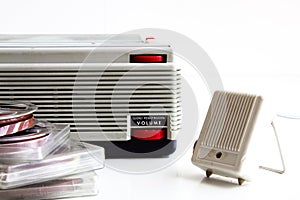 Old tape recorder with magnetic tapes with recordings and microphone on white background