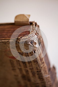 Old tattered book. Sheets of an old thick book. The old pages are tattered, torn. Ancient book