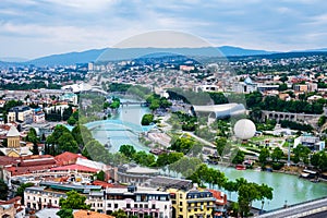 Old Tbilisi from above with Mtkvari or Kura river, bridge of peace, Rike park, hot air balloon, cable car and
