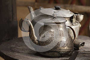 Old teapot and kettle in a kyrgyz yurt kitchen