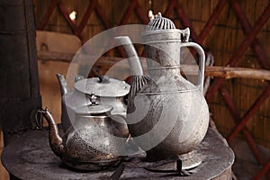Old teapot and kettle in a kyrgyz yurt kitchen
