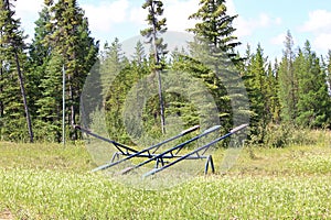 An old teeter totter sits alone in a field