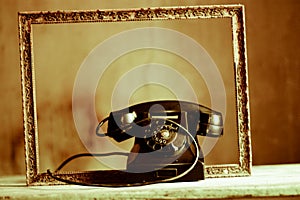An old telephone in an ancient frame