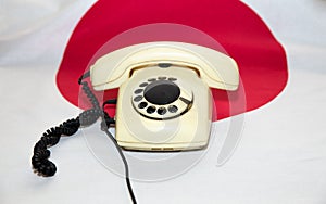 Old telephone is on the background of the Japanese flag. Political negotiations of the leaders of the countries, governments