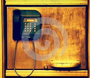 Old telephone on grunge metal wall