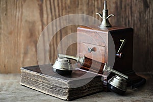 Old telephone and retro book on a wood