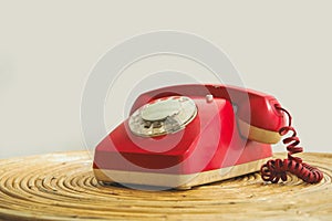 An old telephone with rotary dial, Red vintage phone. rotary telephone on table