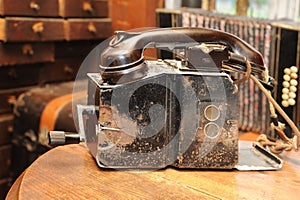 An old telephone set of brown is on a wooden table. Vintage photo of old phone