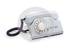 Old telephone set with rotary dial in white plastic housing