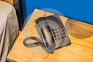 Old telephone with wire and buttons in a hotel