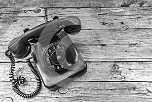 Old telephone on wooden background