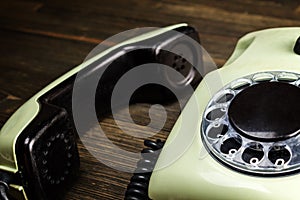 Old telephone on wooden desk