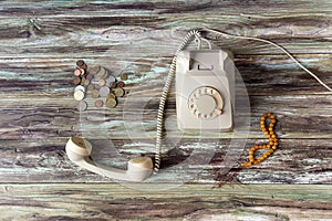 An old telephone on a wooden table