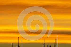 Old television antenna on the roof And orange sky