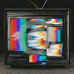 Old television set displaying colorful static and signal issues