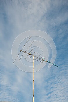 Old televisions antenna on blue sky.