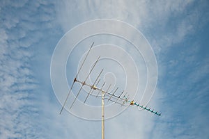 Old televisions antenna on blue sky.