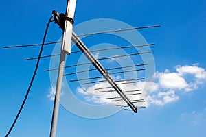 Old televisions antenna on blue sky