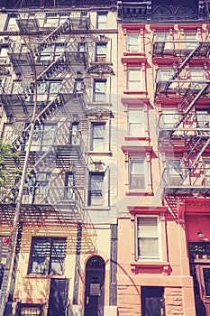 Old tenement house buildings with fire escape, color toned picture, New York City, USA