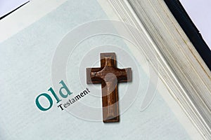 Old testament cover in Holy Bible with a wooden cross photo