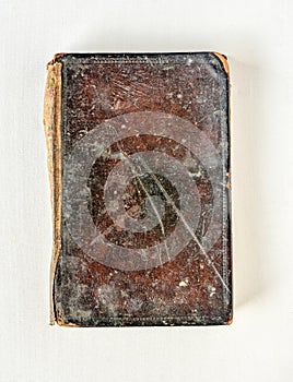 Old textbook with leather cover on white background.