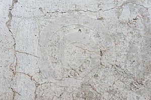 Old texture of white gray whitewash street wall in cracks abstract vintage background