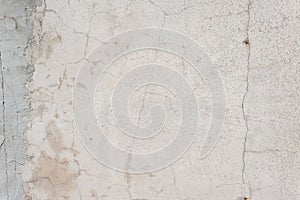 Old texture of white gray whitewash street wall in cracks abstract vintage background