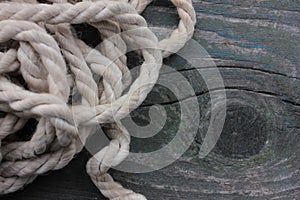 Old textured background. Ship Rope on a rough wooden table. Dark colors. Top view. Copy space